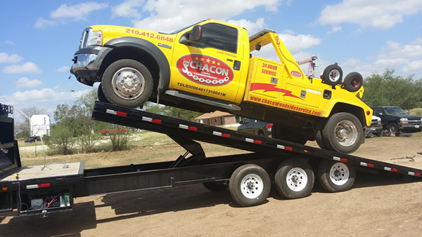 wheel lift tow truck on flatbed tow truck