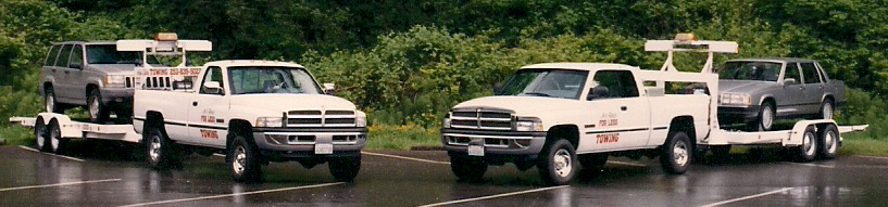 two tow trucks towing business